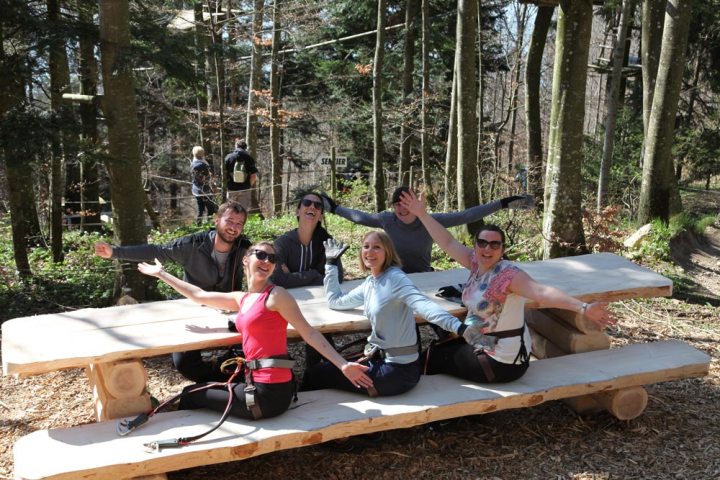 a group of people sitting at a picnic table
