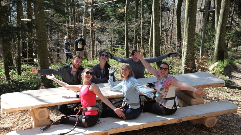 a group of people sitting at a picnic table