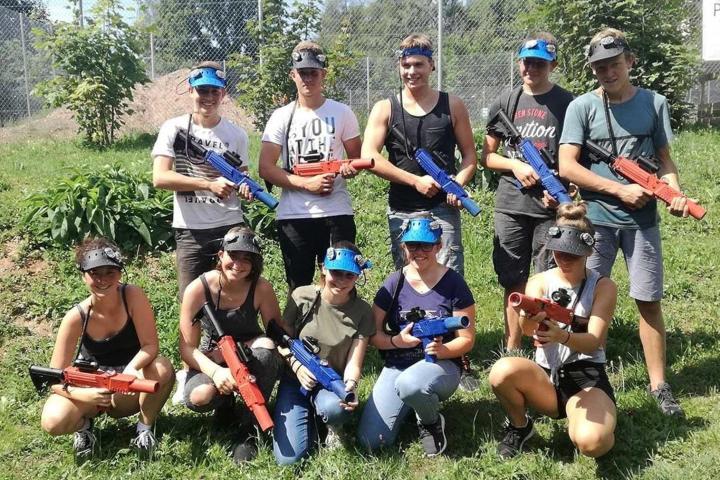 a group of people sitting in the grass