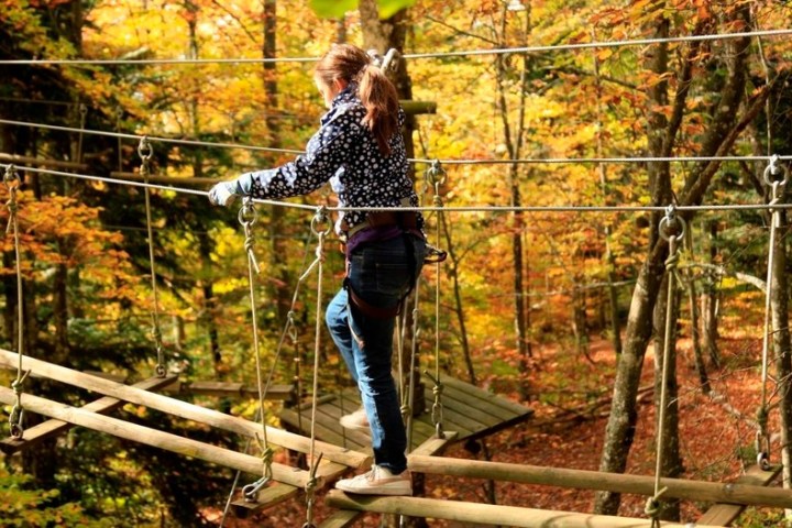 a young man riding a skateboard up the side of a fence